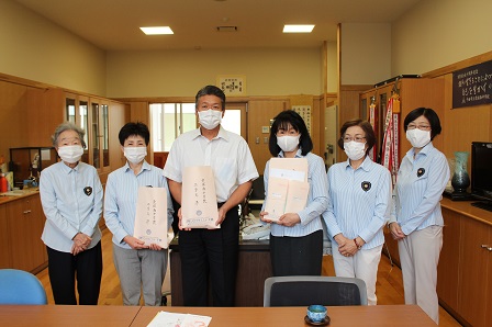 校長と並んで記念撮影をしている国際ソロプチミスト千曲のみなさんの写真