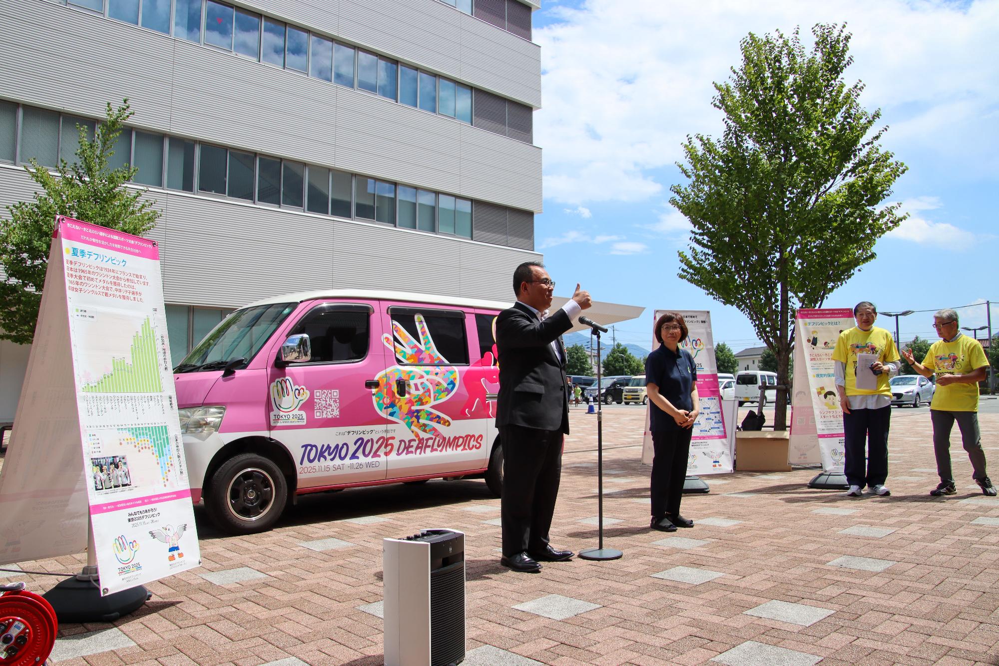 手話を使ってキャラバンカー巡回の歓迎のあいさつをする小川市長