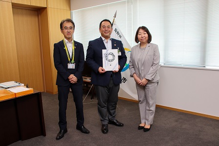 市長、支店長、校長がカメラのほうを向いて並んで記念撮影をしている写真