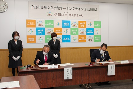 更埴文化会館ネーミングライツ協定書へ署名する様子