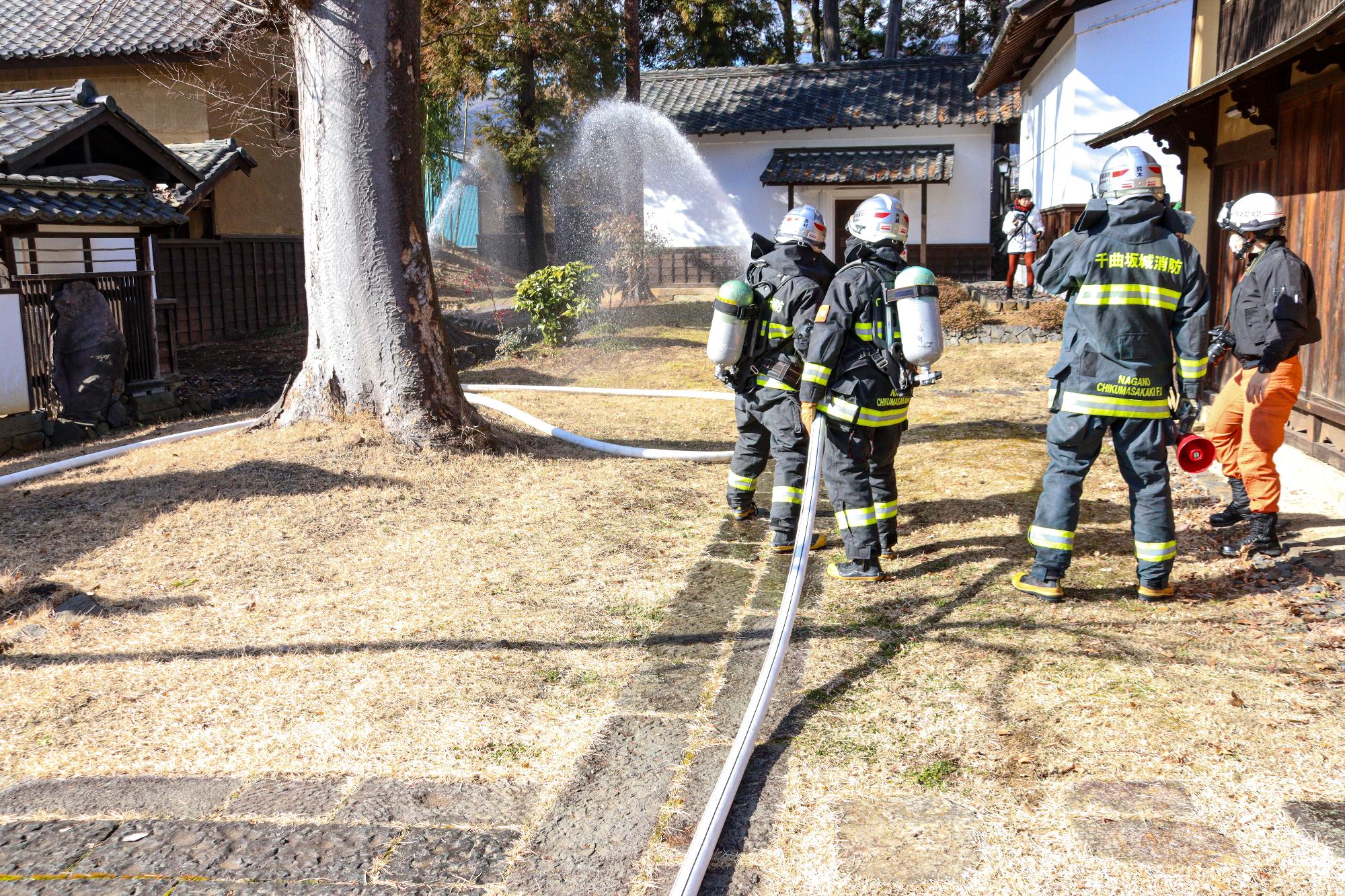 消防署職員による放水の様子を後方から撮影