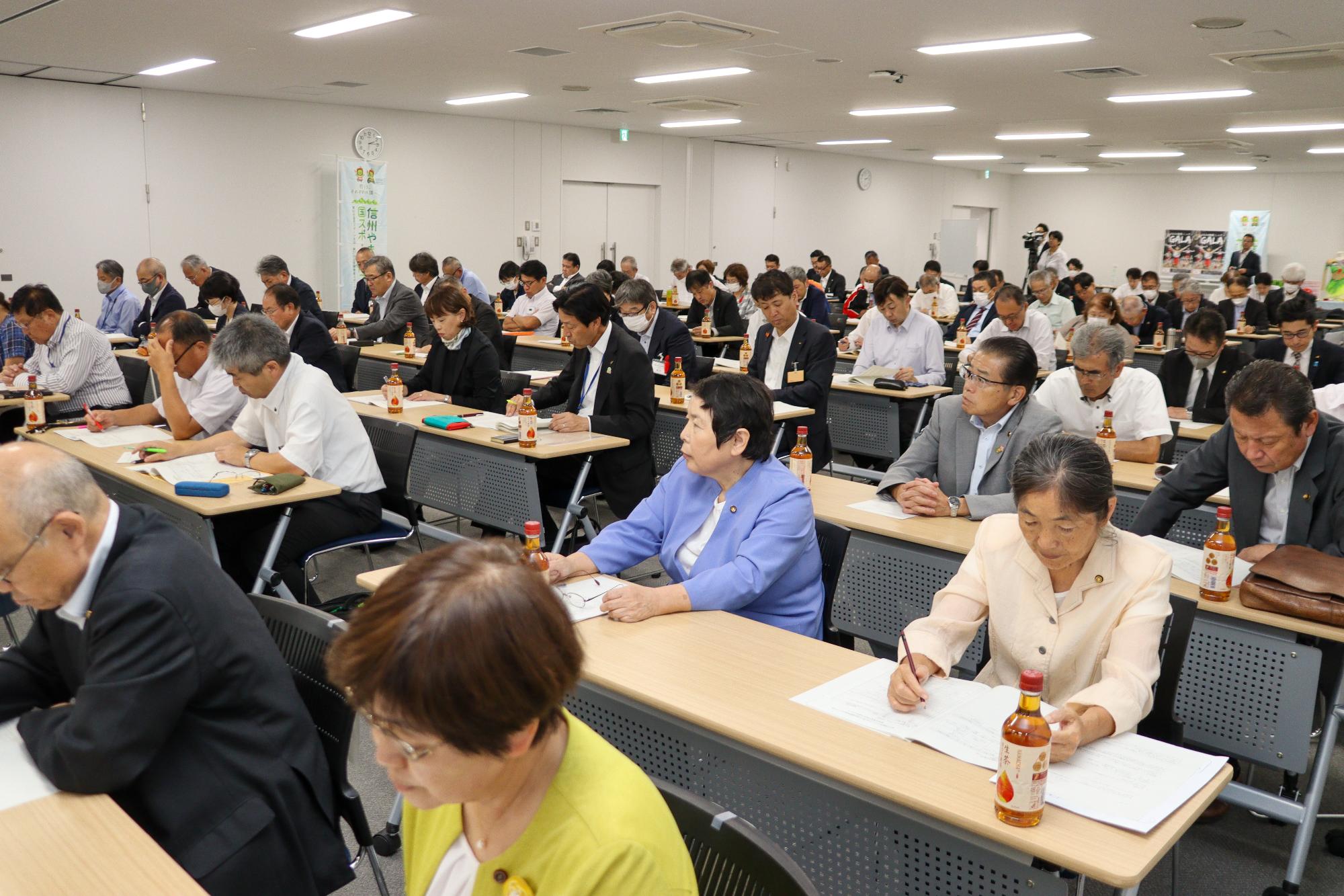 熱心に話を聞く参加者約80人