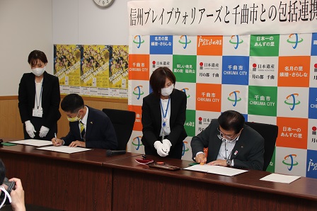 片貝さんと市長が協定書に署名をしている写真